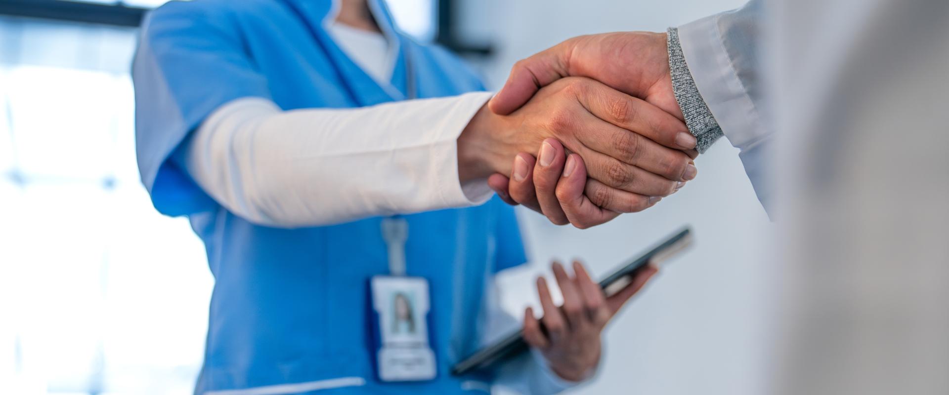 2 medical professionals shaking hands