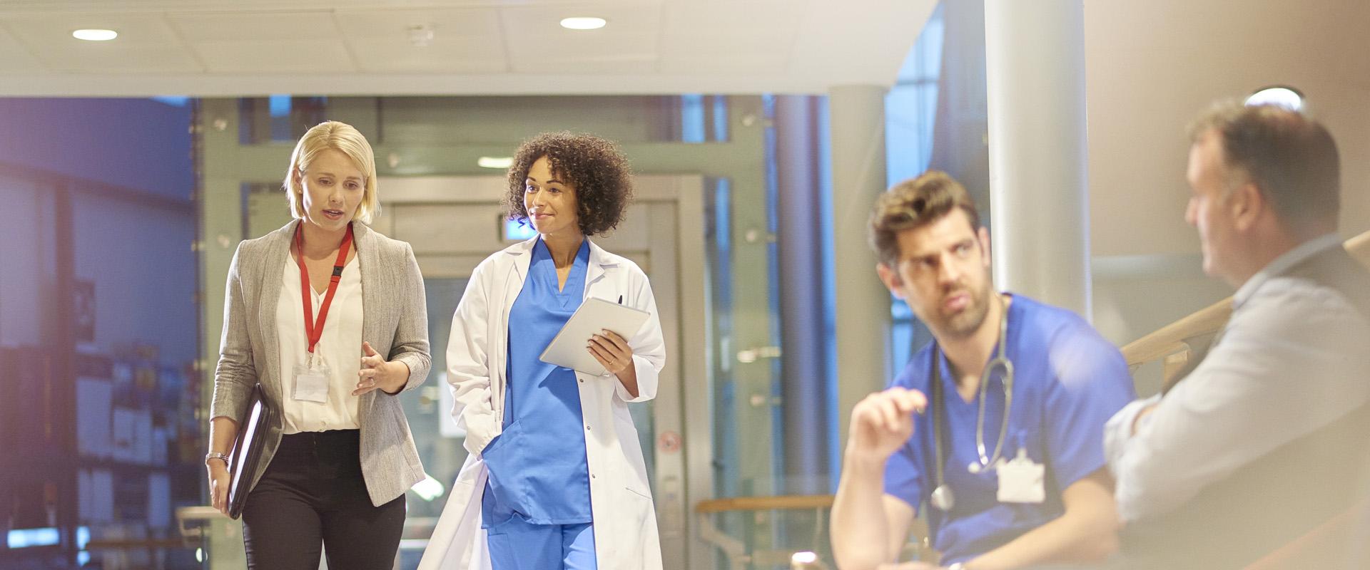 Doctors talking with other medical professionals in hospital