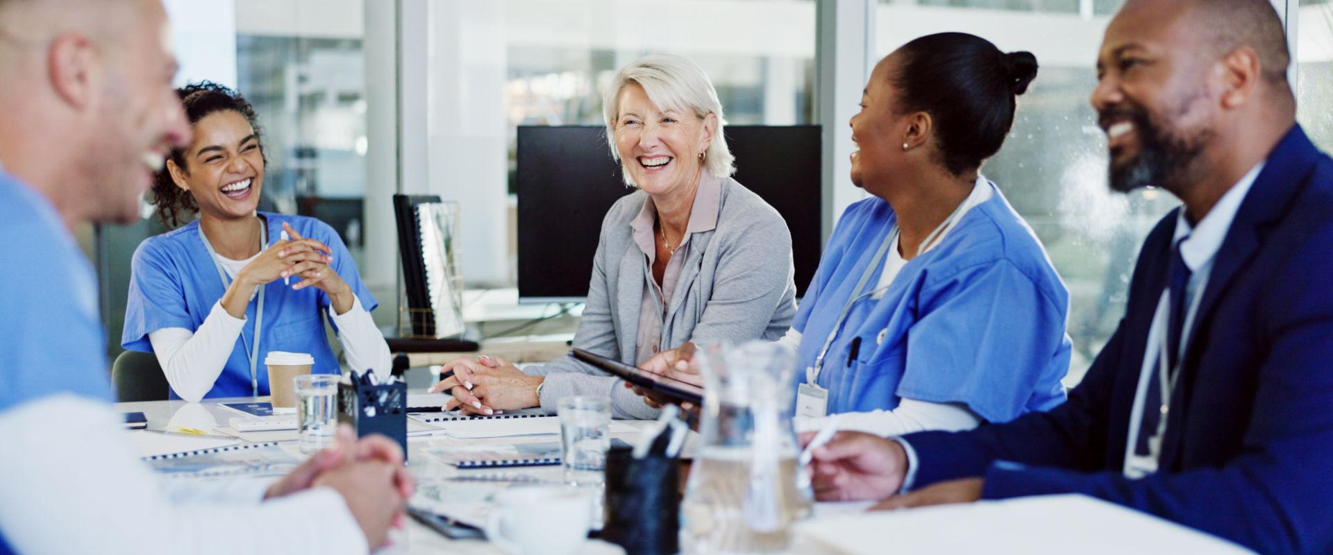 Group of medical professionals talking around a table