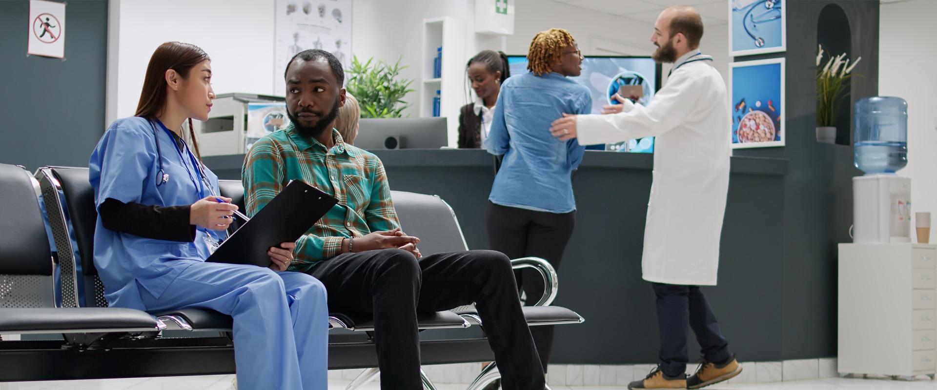Doctor speaking with patient in hospital lobby